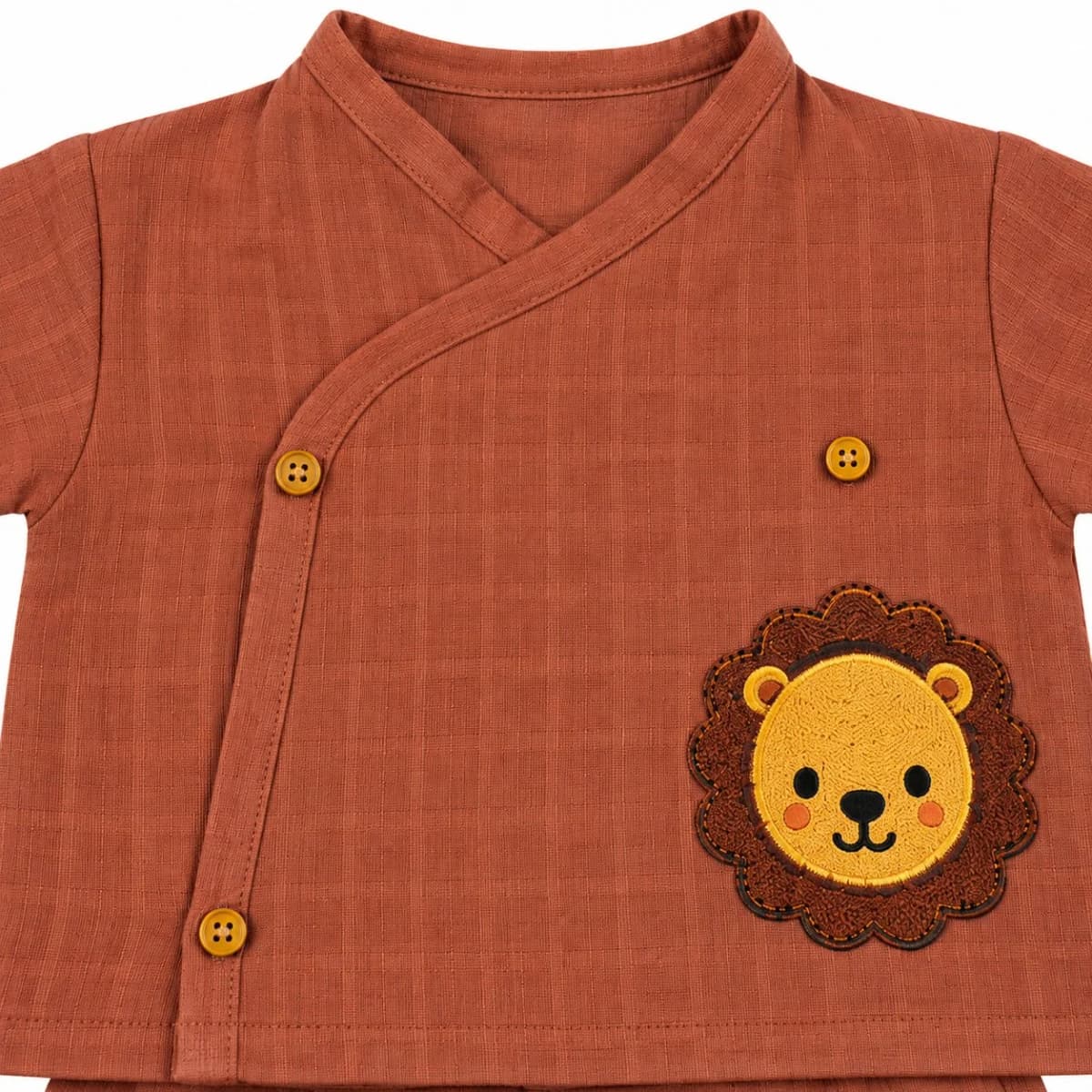 Close-up of the lion bamboo muslin coord set and its wooden buttons